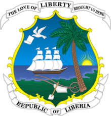 The emblem of Libya: a golden hawk carrying a scroll inscribed with Arabic text, shown on a white field.