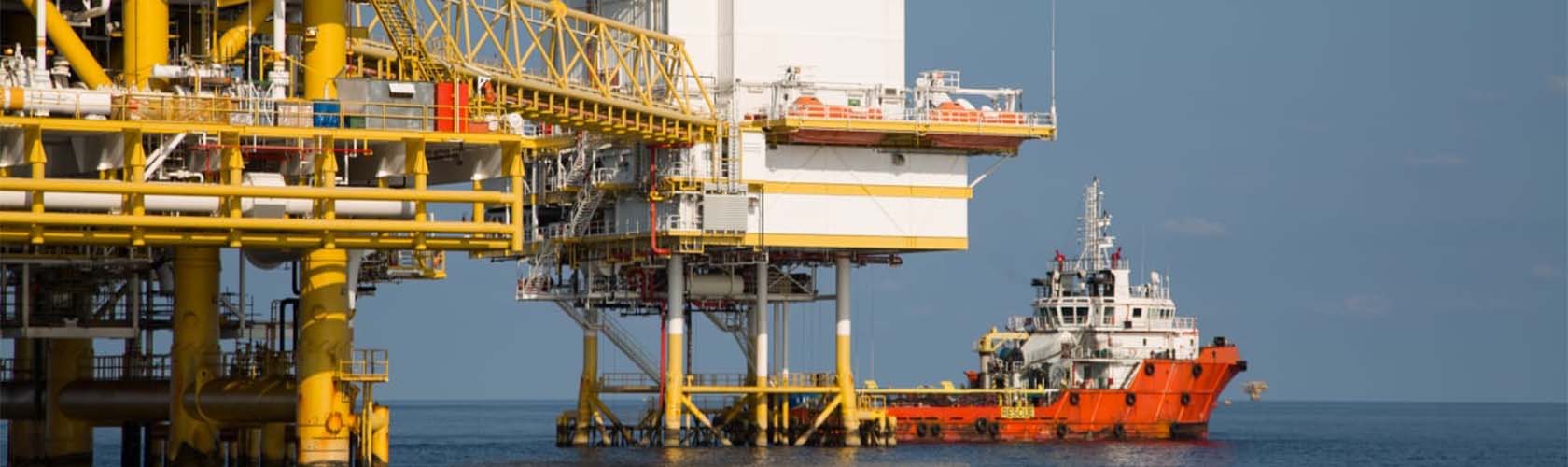 An oil platform in the ocean with a tugboat. Illustration of maritime industries and the Merchant Navy course.