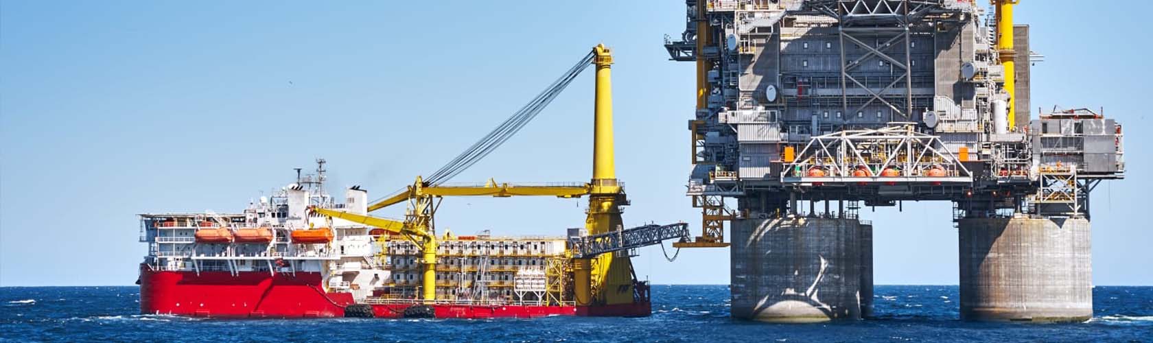 An oil platform in the ocean with a tugboat. Illustration of maritime industries and the Merchant Navy course.